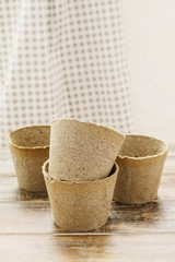 Paper pots on wooden table.