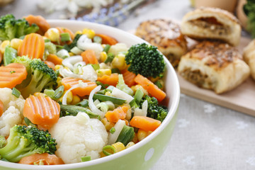 Spring vegetable salad in green dotted bowl.