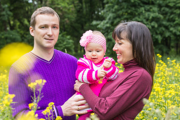 Dad, mom and little baby in the Park