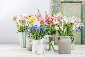 Fototapeta na wymiar Spring flowers on wooden table.