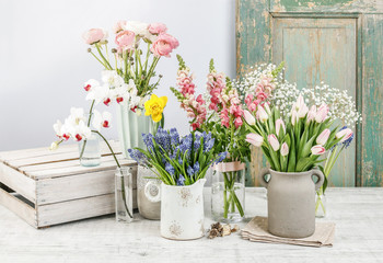 Spring flowers on wooden table.