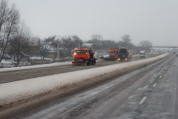 Snow plow removing snow from city road