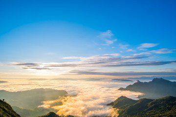 Beautiful sunrise scene at high mountain with yellow clouds and blue sky, Phu chi fah Chiangrai Thailand