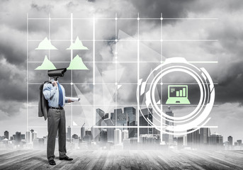 Camera headed man standing on wooden floor against modern citysc