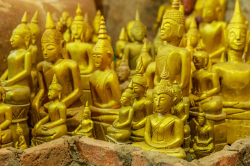 The wooden Buddha statue   in the old buddhist temple 300 year old in the countryside of Thailand.