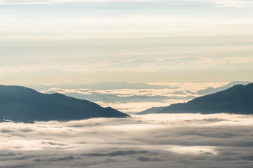 Fototapeta premium Beautiful sunrise scene at high mountain with yellow clouds and blue sky, Phu chi fah Chiangrai Thailand