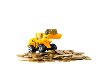 Mini bulldozer truck loading stack coin with pile of gold coin, isolated on white background with copy space, business finance and banking industrial concept.