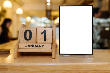 Mock up Menu frame in Bar restaurant ,Stand for booklets with white sheets of paper acrylic tent card on wooden table on.