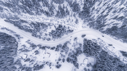Aerial view of a road in idyllic winter landscape. Winter traffic conditions