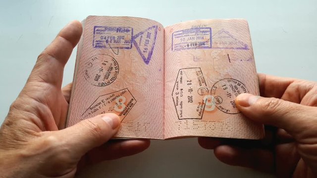 Close-up of a foreign passport in the hands of a man.