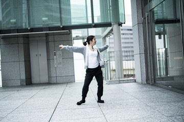 Fototapeta na wymiar A woman dancing in an office town