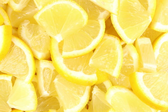 pieces of fresh lemon fruits closeup food background texture