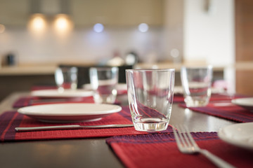 Restaurant table setting with empty glasses;red cloth plate