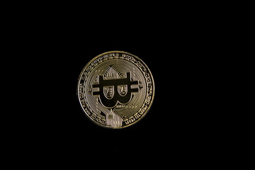 The gold bitcoin on a black background