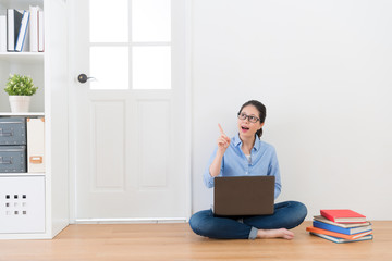 woman sitting on floor at home using computer