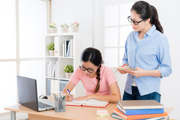 young female college student doing school homework