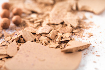 close-up shot of crushed nude cosmetic powder on white