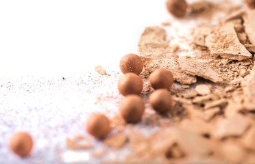 close-up shot of crushed nude cosmetic powder on white