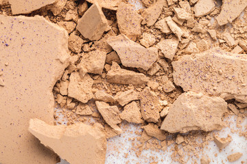 top view of spilled nude cosmetic powder as background