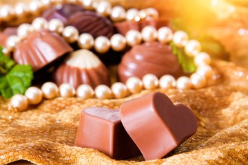 assortment of chocolate pralines with pearl necklace