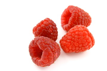 fresh red raspberry fruits isolated on a white background
