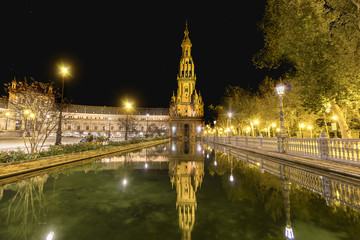 Spain Square (Plaza de Espana) at night, Seville, Spain, built on 1928, it is one example of the Regionalism Architecture mixing Renaissance and Moorish styles - obrazy, fototapety, plakaty