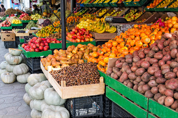 Seasonal fruits and vegetables - potatoes, pumpkins, chestnuts, mandarins, persimmons, apples, bananas and other local market in Georgia.