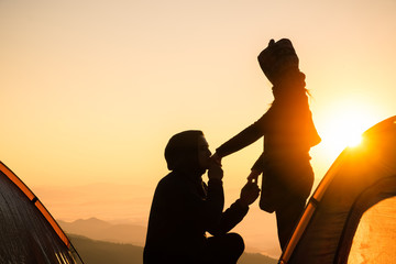 Fototapeta na wymiar Silhouette Romantic couple in love ,man and women hold hands in nature ,sky with cloud in sunrise or sunset time
