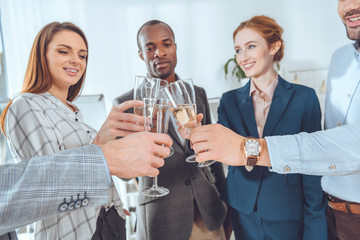 business team celebrating with beverage in glasses at office space