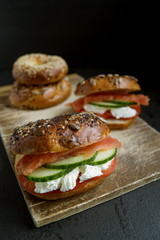 Bagels with cream cheese and smoked salmon on a black background