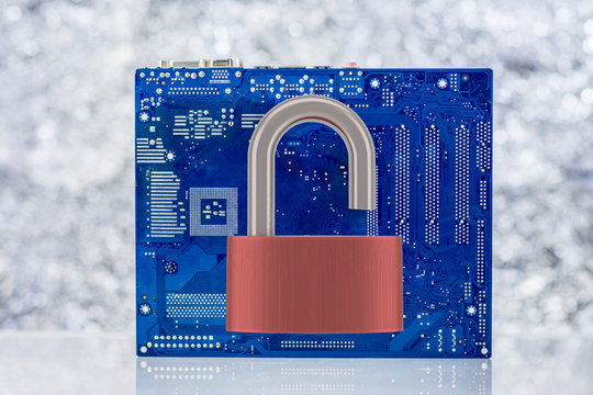 Computer Motherboard With Unlocked Padlock On Light Background. Vulnarable To Attack  Concept.