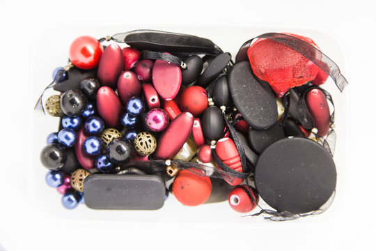 Beautiful colorful jewelry making beeds on white background. Shallow depth of field. Hand craft supplies.