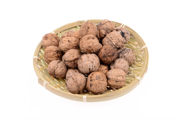 The basket of walnuts on a white background
