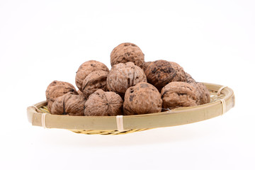 The basket of walnuts on a white background