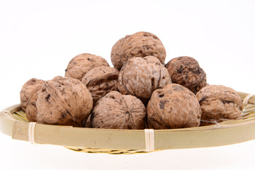 The basket of walnuts on a white background