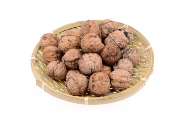 The basket of walnuts on a white background