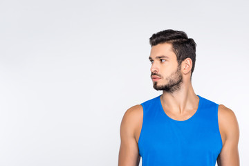 portrait of handsome young sportive man looking away isolated on white