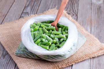 Frozen string beans on a wooden table