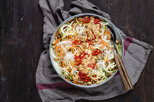 Vegan salad, spiralized zucchini and carrot with glass noodles and spicy peanut dressing
