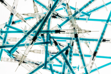 A lot of transparent medical syringes. Close up shot, white background.