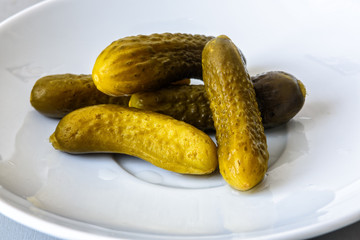 pickled gherkins on a white plate