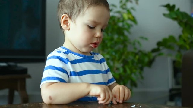 Baby boy having fun while playing with plasticine

