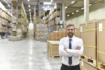 Portrait of confident businessman standing in warehouse