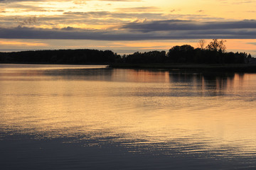 Fototapeta na wymiar Sunset over Sirvenos Lake in Lithuania.