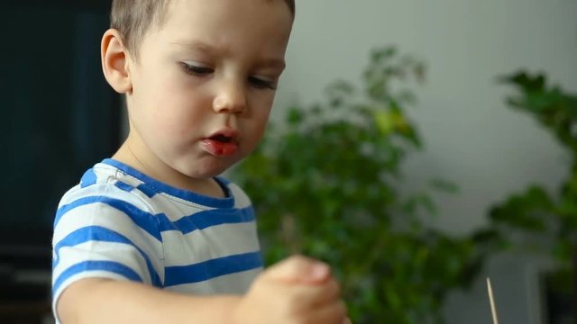 Little boy looks happy while playing with plasticine
