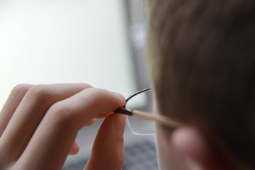 young man with glasses working on computer