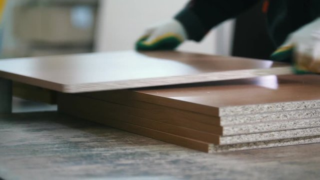 Stack of prepared wooden particleboard boards on the furniture factory
