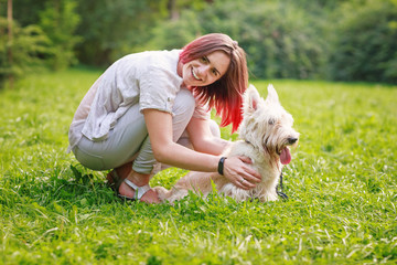 Young girl with a dog in the park