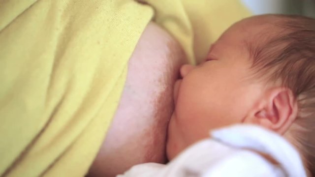 Mother breast feeding her newborn baby
