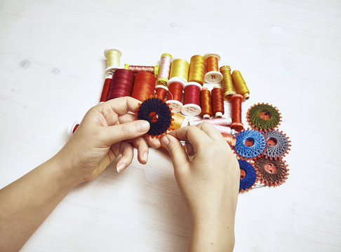 Hand with sewing utensils